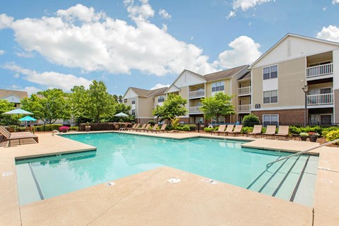 Swimming Pool with Sundeck Seating and Building Exterior in the Background